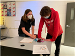 Two students plan their ad